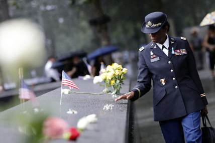 A retired colonel from the U. S. Army Nurse Corps walks beside the reflecting pool at the commemoration ceremony on the 21st anniversary of the September 11, 2001 terror attacks on Sunday, Sept. 11, 2022 in New York.  AP/RSS Photo